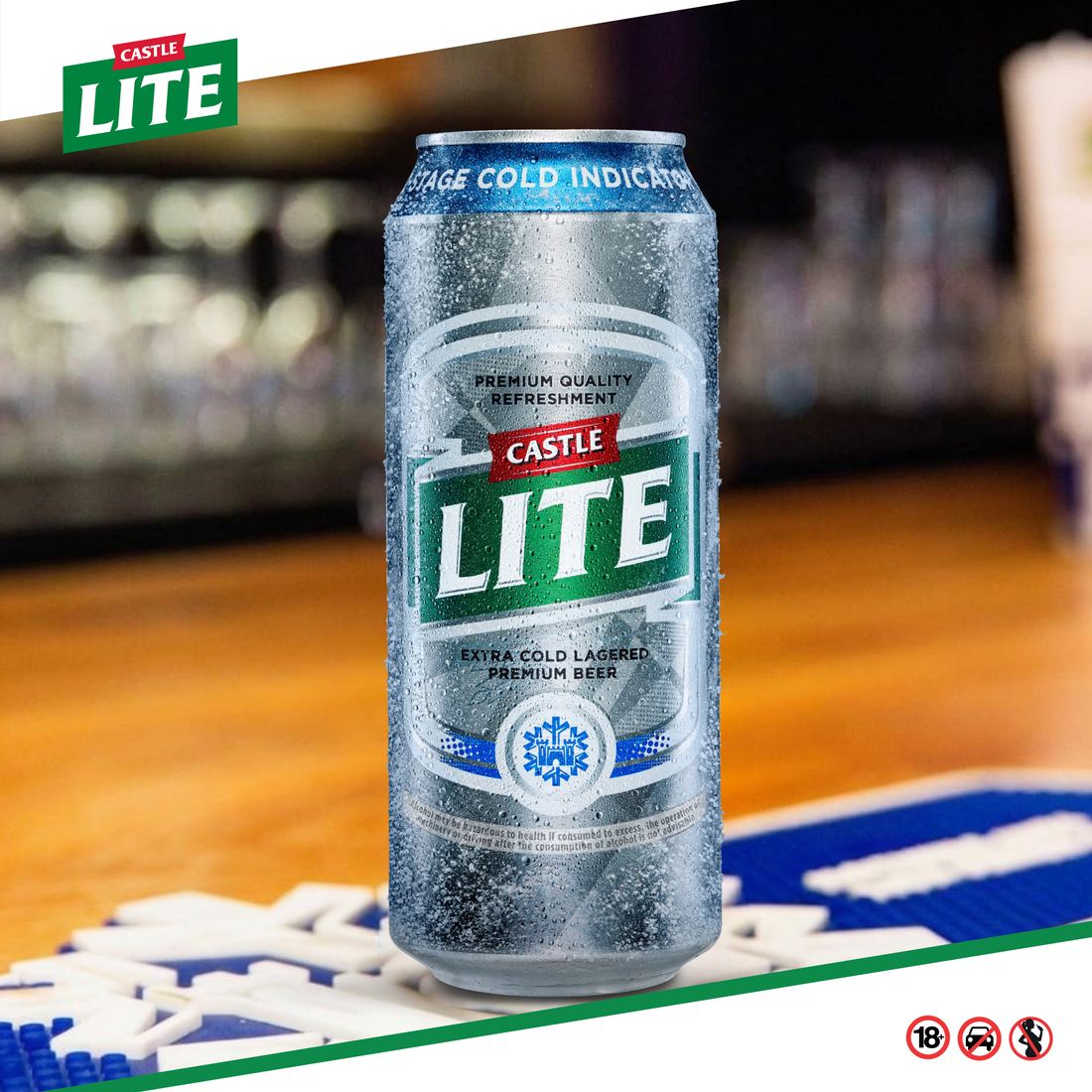 A cold Castle Lite can on a bar counter